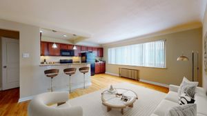 Modern open-concept living area with elegant kitchen, featuring bar seating and stylish d&eacute;cor, perfect for entertaining.