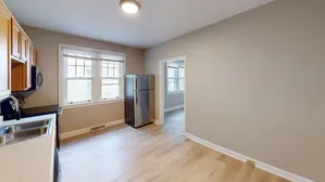 Contemporary kitchen with stainless steel appliances and large windows offering natural light.