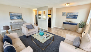 Charming living room with contemporary furnishings, soft neutral tones, and a cozy seating area, perfect for relaxation and comfort.