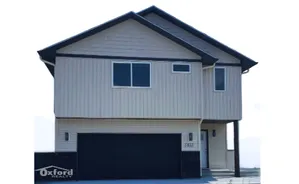 Modern two-story home with sleek design, featuring a spacious garage and elegant exterior finish, ideal for comfortable living.