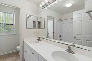 Full bath with double-sink vanity.