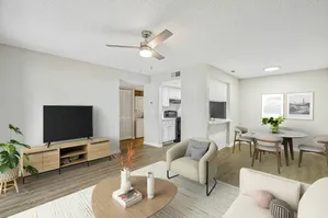 Aria Executive model rendering white walls oak planking moder furniture with area rug including dining area living area with galley kitchen in background