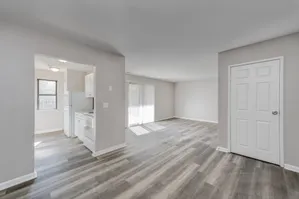 Bright and airy open-concept living space with modern kitchen and stylish flooring, perfect for contemporary living.