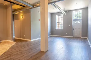 interior of large loft, looking at front door and windows