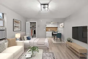 Cozy studio apartment with modern furnishings, offering an open-concept layout, stylish seating area, and compact kitchen with dining space.