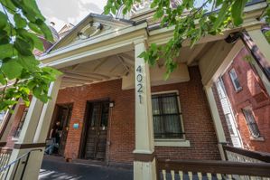 Charming brick townhouse with classic architectural details and inviting front porch.