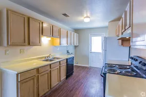 Kitchen with wood cabinets and black range at Countryside Village in Memphis, TN