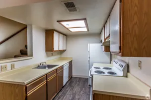 Kitchen with wood cabinets and white appliances at Hickory Forest in Memphis, TN
