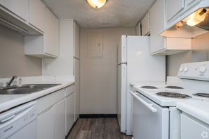 Kitchen with white cabinets in 2 bedroom townhome at Meadow Creek Apartments in Jackson, MS