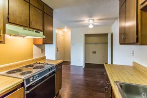 Kitchen with wood cabinets and a range hood at Hickory Pointe in Memphis, TN