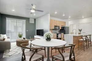 Modern open-concept living area featuring a sleek kitchen, a cozy dining space, and a comfortable lounge with stylish decor.