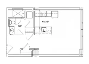 Modern floor plan featuring a spacious kitchen and an adjacent bathroom, ideal for compact living.