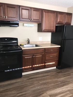 Cozy kitchen featuring elegant wooden cabinetry and modern appliances.