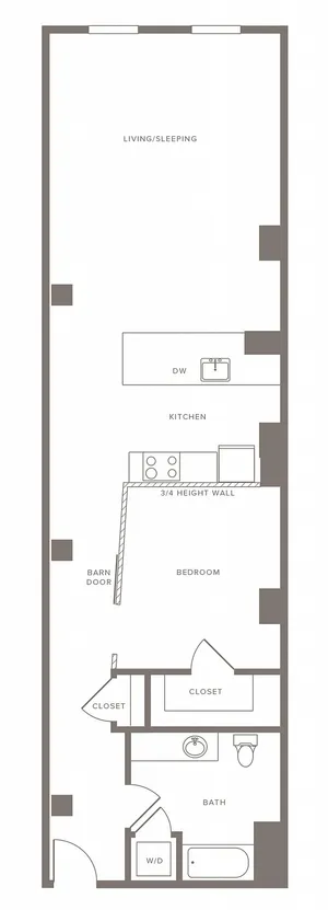 Sleek floor plan with spacious living/sleeping area, modern kitchen, and cozy bedroom featuring a barn door entry.