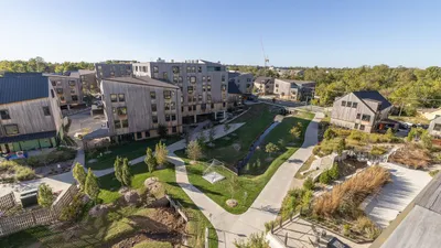 Charming modern apartment complex with greenery, scenic pathways, and contemporary wooden architecture.