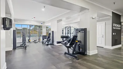 Modern fitness center with state-of-the-art gym equipment, sleek flooring, and motivational decor.