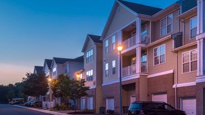 Charming apartment complex at dusk with inviting balconies and modern architecture.