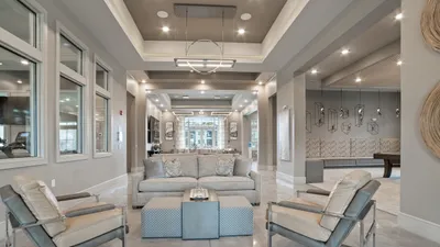 Sophisticated apartment lounge with modern decor, plush seating, and elegant lighting, perfect for relaxation and social gatherings.