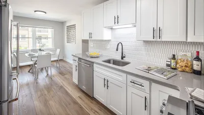 Bright, modern kitchen with sleek white cabinets, elegant countertops, and charming breakfast nook.