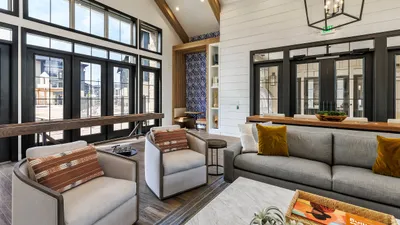 Bright and airy living space with high ceilings, elegant neutral decor, and large windows inviting natural light.