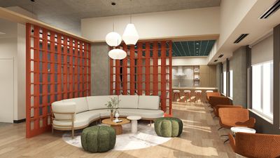 Modern open-concept living area with stylish cream sectional, vibrant red divider, and sleek kitchen space.