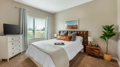 Spacious bedroom with large window and stylish decor at The View at Cedar Park luxury apartments in Cedar Park, TX