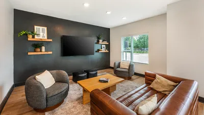 Open-concept living room with cozy seating at The View at Cedar Park luxury apartments in Cedar Park, TX