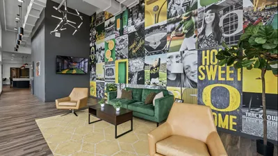 Contemporary lobby with vibrant mural, stylish seating, and modern lighting, offering an inviting and artistic atmosphere.