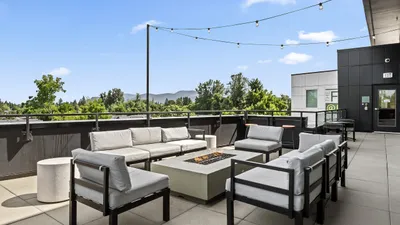 Chic outdoor terrace with cozy seating, a stylish fire pit, and stunning mountain views, ideal for relaxation and gatherings.