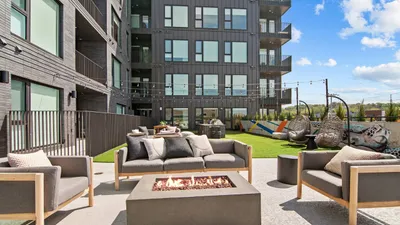 outdoor fire pit and green space with seating