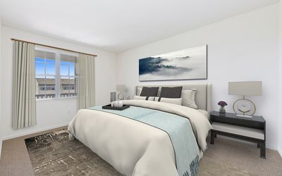 Elegant bedroom with tranquil decor, large window, and cozy bedding creating a serene atmosphere.