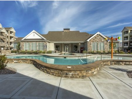 Swimming pool, hot tub, and grills shown in front of the clubhouse
