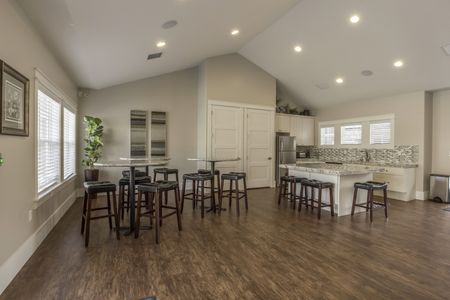 Activity Center Entertaining area with full kitchen, 3 bar-style tables, and 12 bar stools