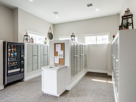 Indoor mail room with community pin-board, vending machine, and trash area