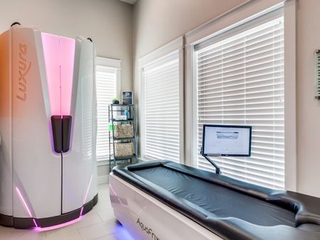 Tranquility room with standing tanning machine and water massage bed