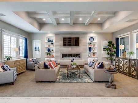 Kensington clubhouse waiting room with flat screen television and fireplace