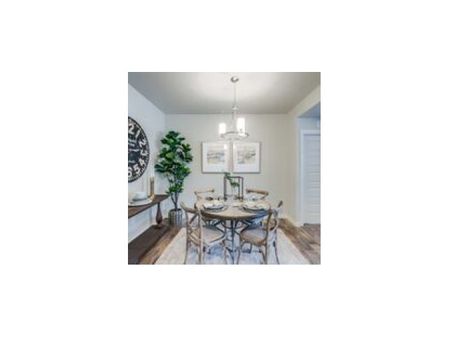 dining room with 4 person circular dining table and dishware credenza