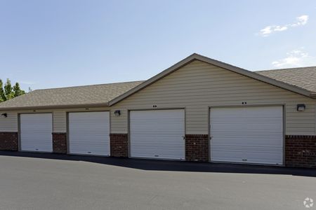 Detached garage building showing 4 standard storage garages with padlocks and hand-levers for access