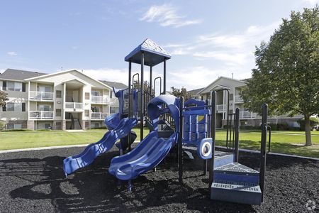 Playground area in black rubber tire bit pit with 4 slides