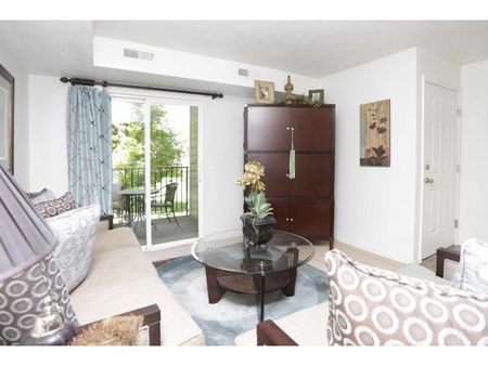Living room with 1 couch, 1 loveseat, large armiore, and coffee table