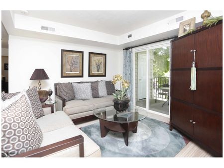 Living room with 1 couch, 1 loveseat, large armiore, and coffee table