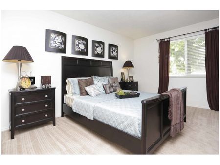 Master bedroom with queen bed, 2 nightstands, and one large window
