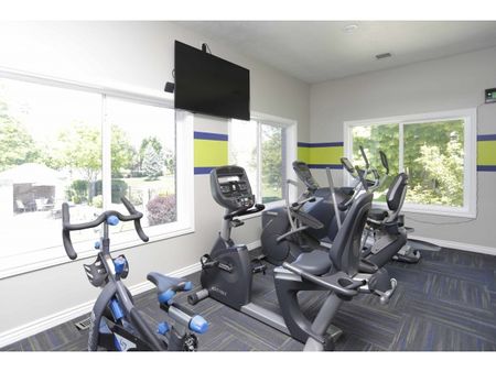 Fitness center with flat screen television and 3 stationary bikes