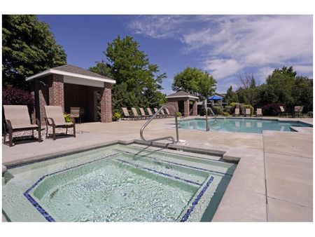 Square hot tub in front of large angular pool