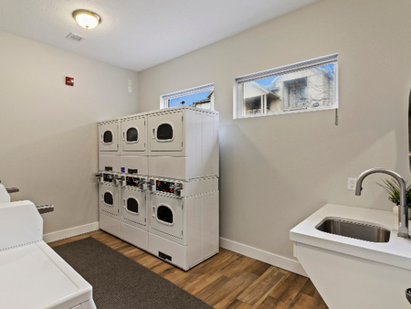 Laundry area with four washer, six dryers and sink