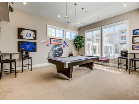 Game room with billiards table, flat screen television, and seating areas