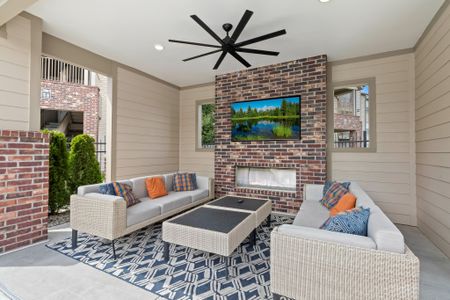 Outdoor cabana areas with couch seating tables and large TV & fireplace