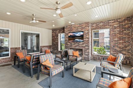 Outdoor patio area with seating, TV and fireplace