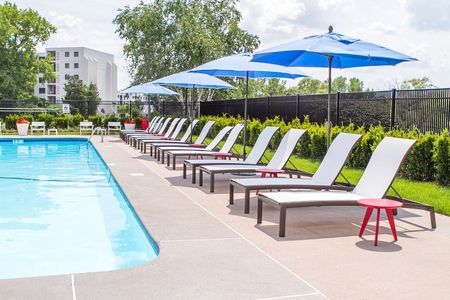 Apartment Pool Area With Umbrellas and Chairs