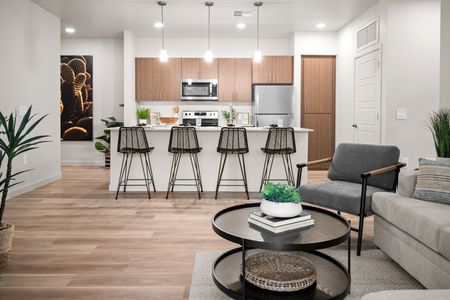 Apartments for Rent in Queen Creek - Acero Harvest Station - Kitchen with Kitchen Island, High Chairs, Cabinetry, and Stainless-Steel Appliances